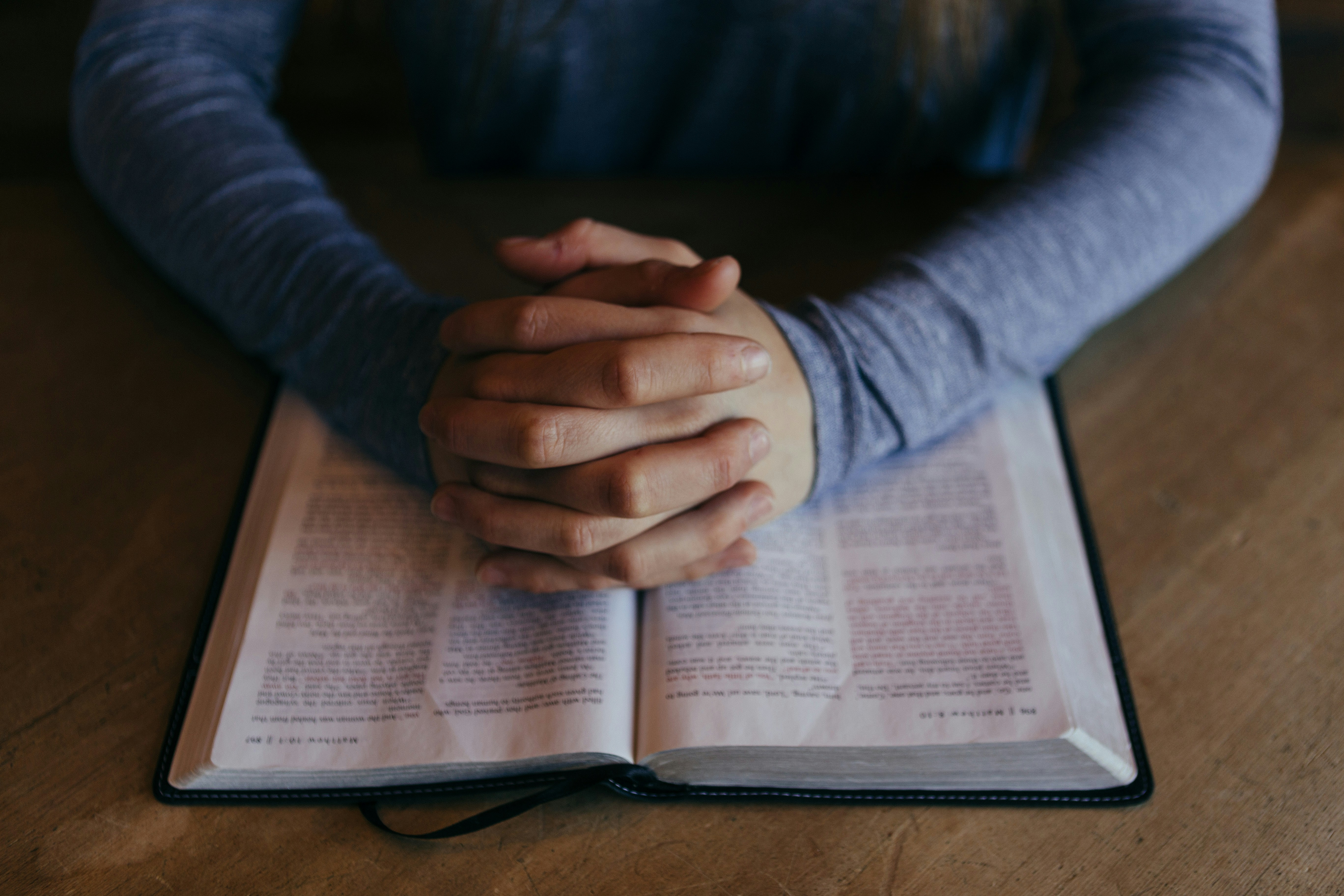 Foldede hænder og bibel